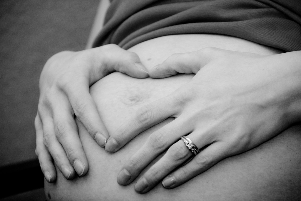 Pregnant woman with heart hands