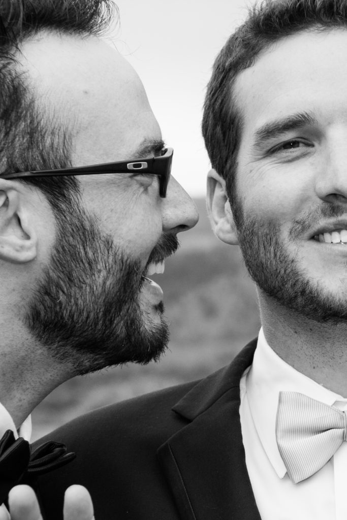 Groom with groomsman close to his face