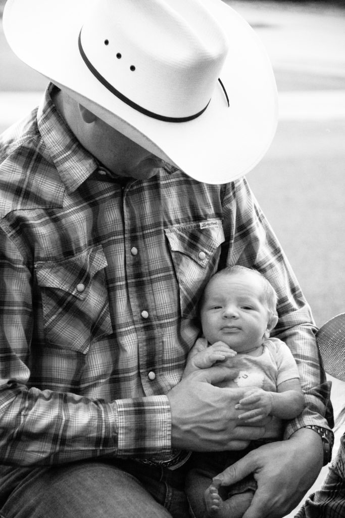 Cowboy holding baby
