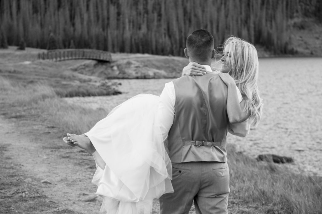 Bride being carried by her groom.