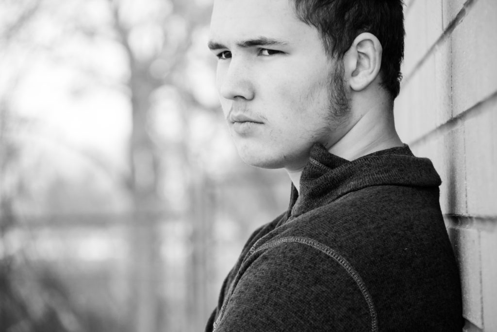 Teenage boy looking out into the horizon.