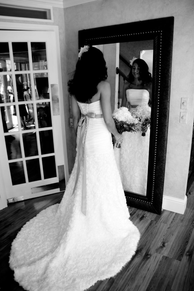 Bride looking into mirror