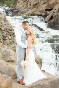 bide and groom kissing by waterfall in South Fork