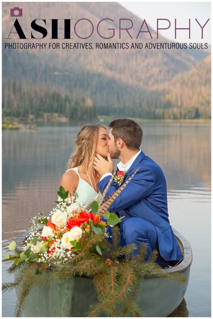 bride and groom kissing in a canoe on a lake