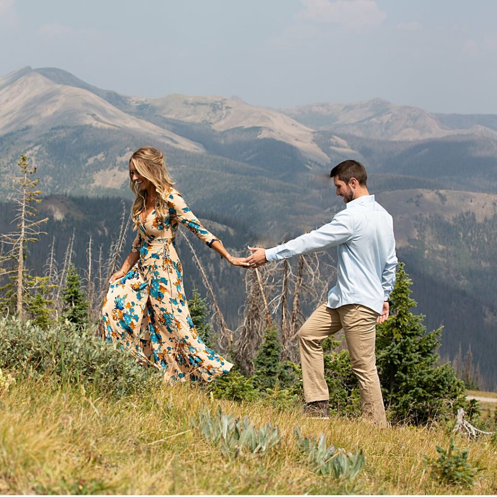 couple walking hand in hand through mountain vistas in southern Colorado