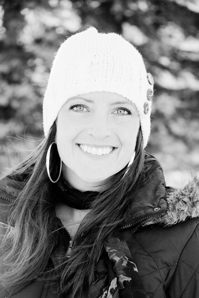 photographer ashlee bratton in a winter hat and coat smiling at the camera